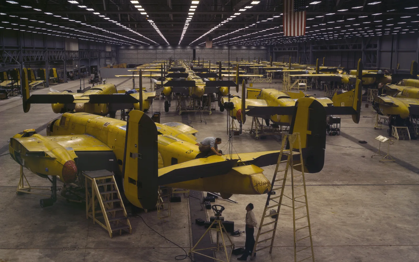 Black and white photograph of North American Aviation workers assembling B-25 bombers during World War II
